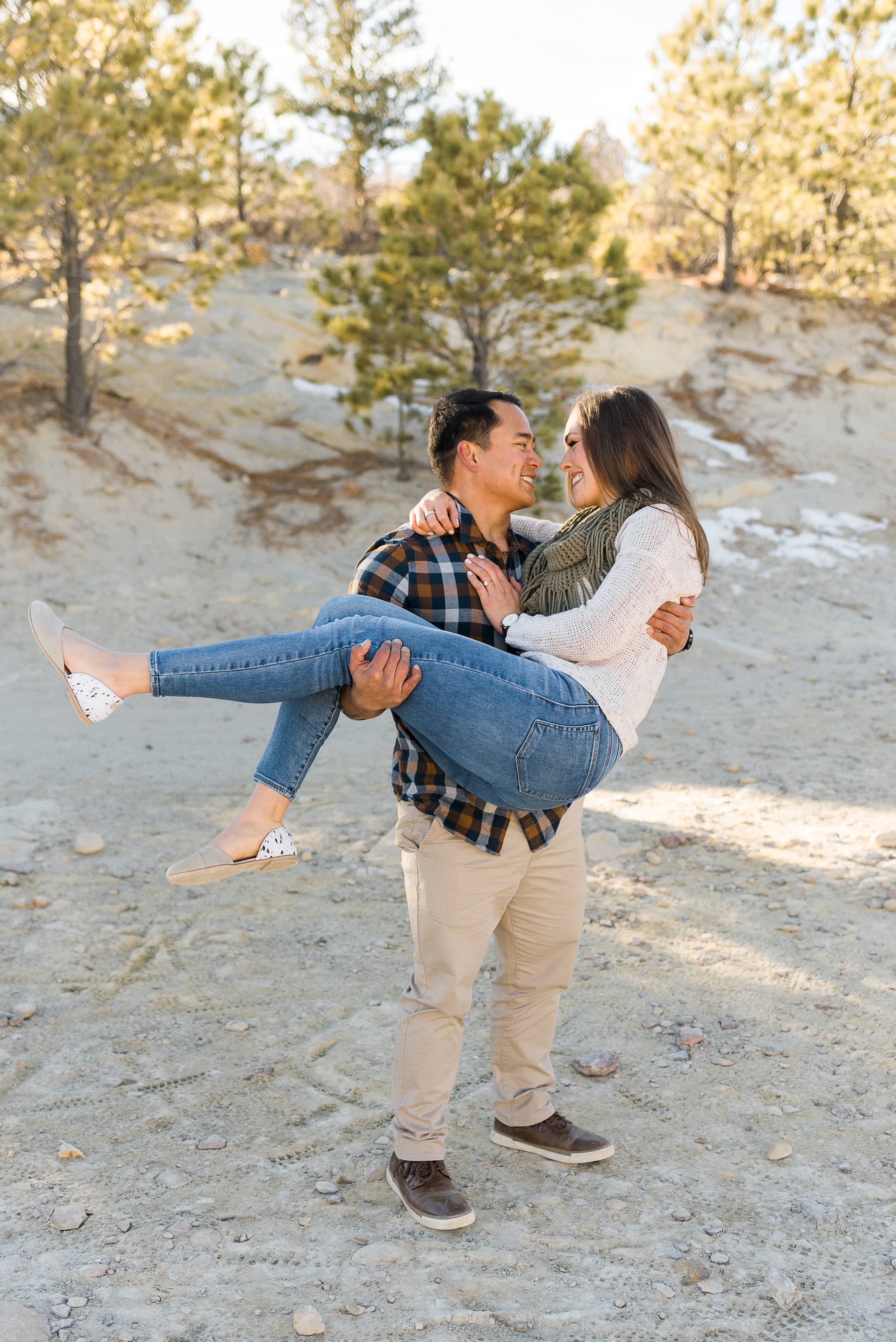 Guy picking up girl for colorado springs engagement photos