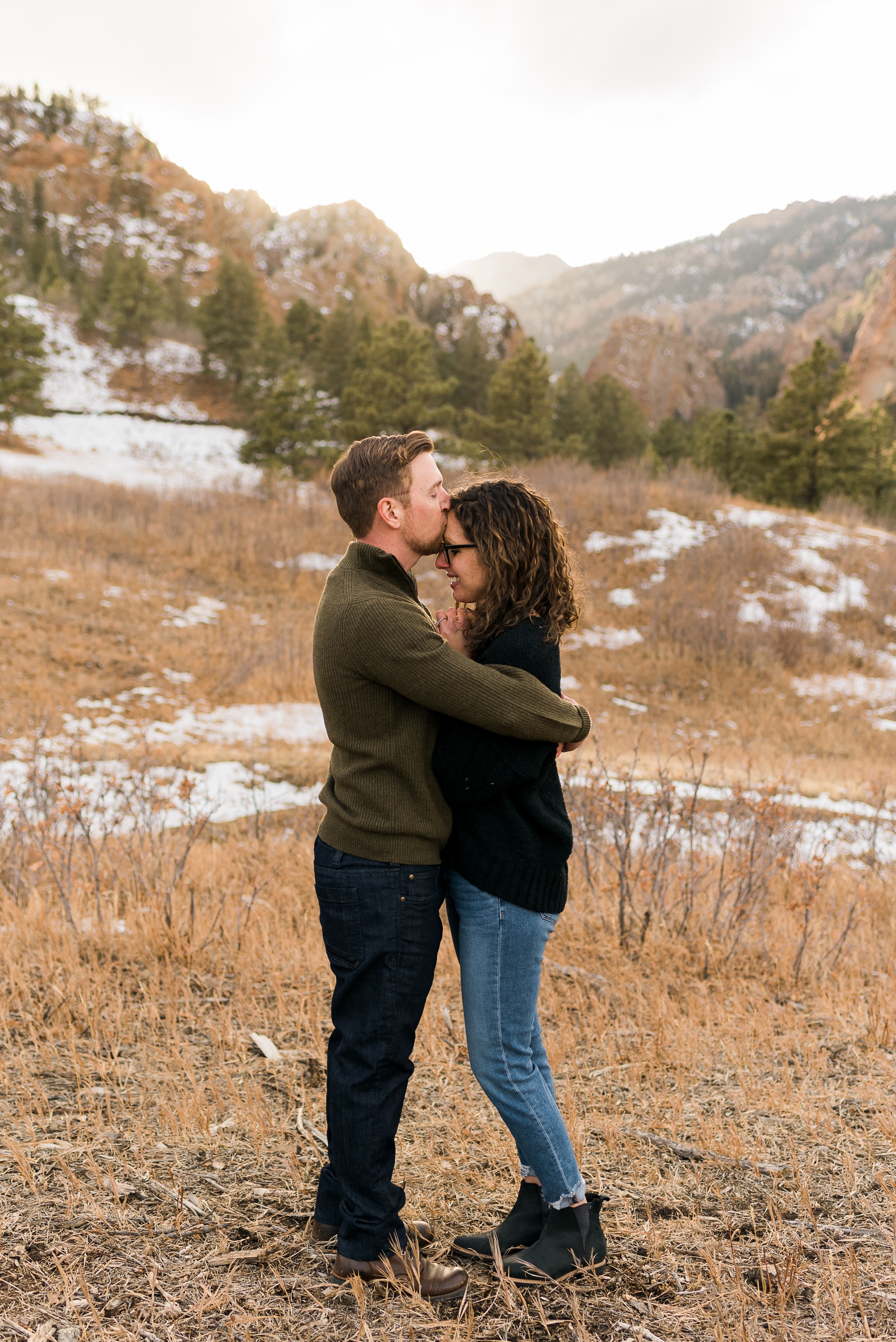 man giving forehead kiss for engagement photos