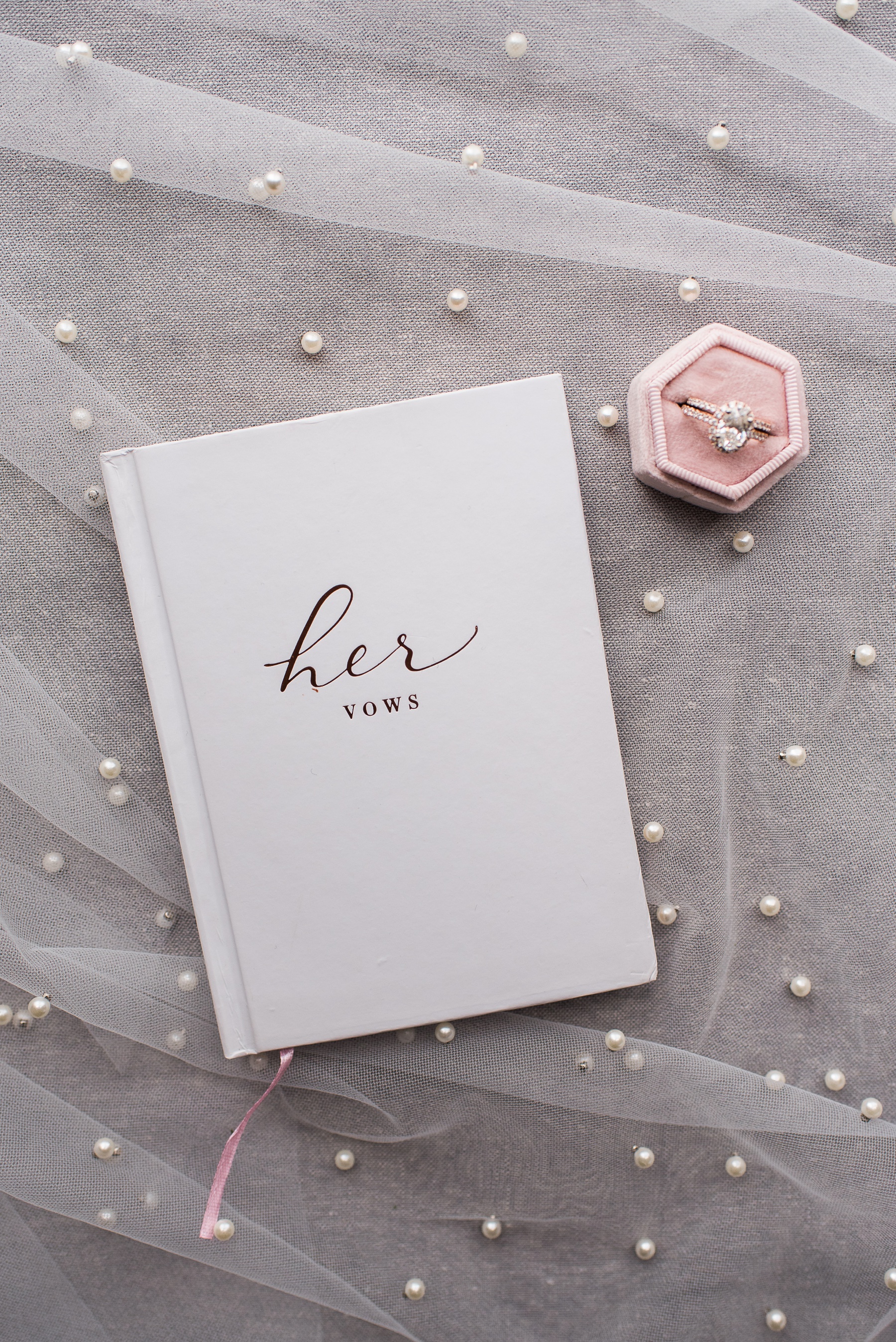 Her Vow book and ring in pink ring box. 