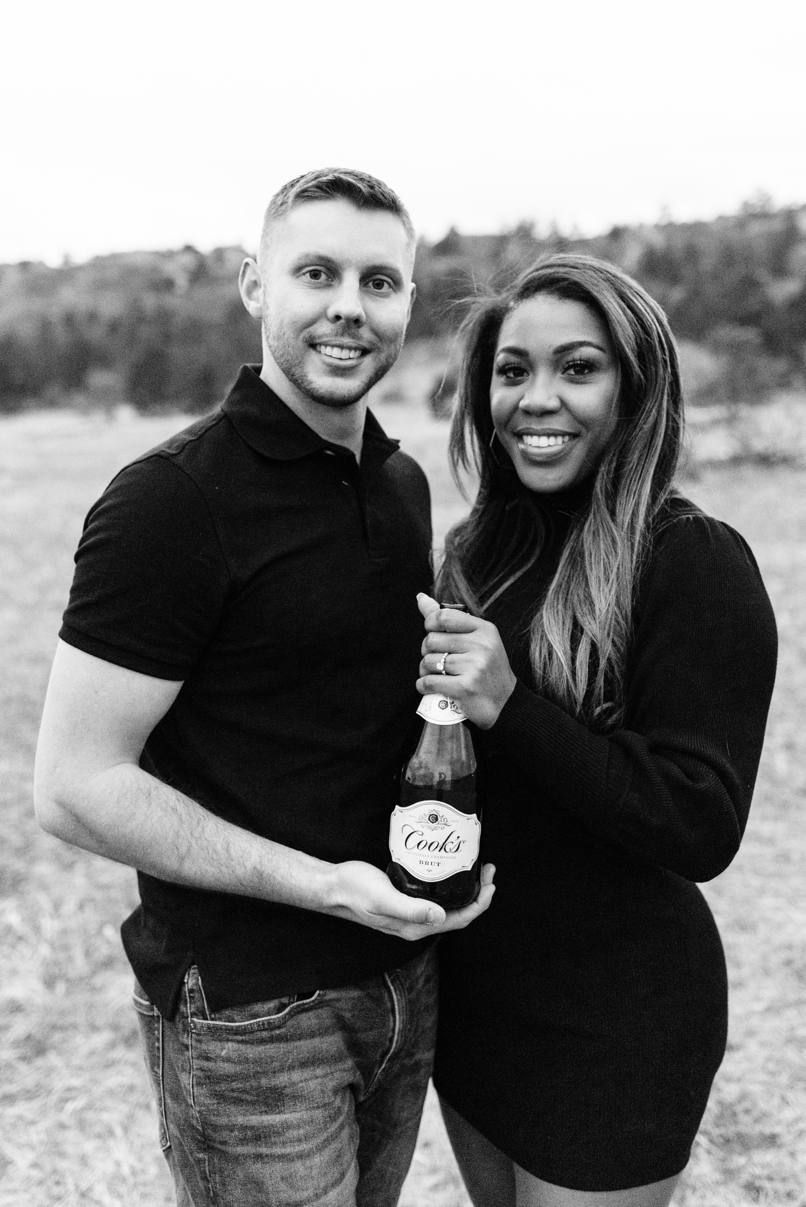 Couple holding champagne bottle