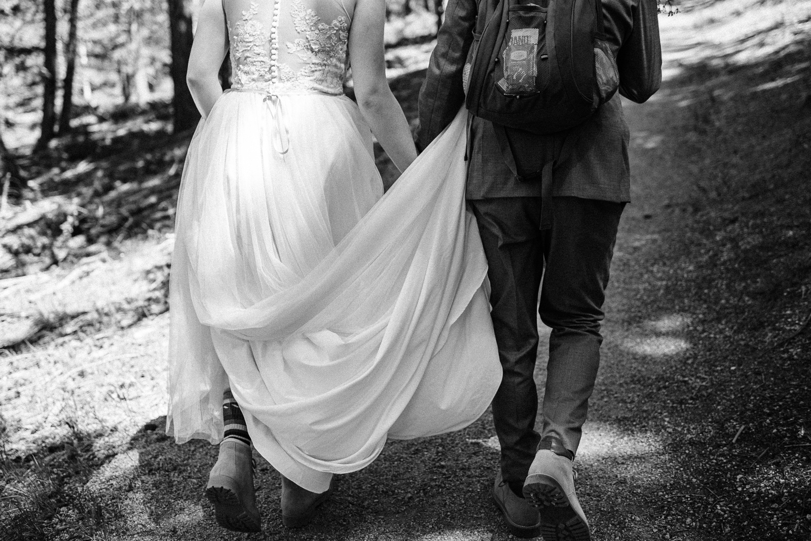 Back of wedding dress and hiking boots