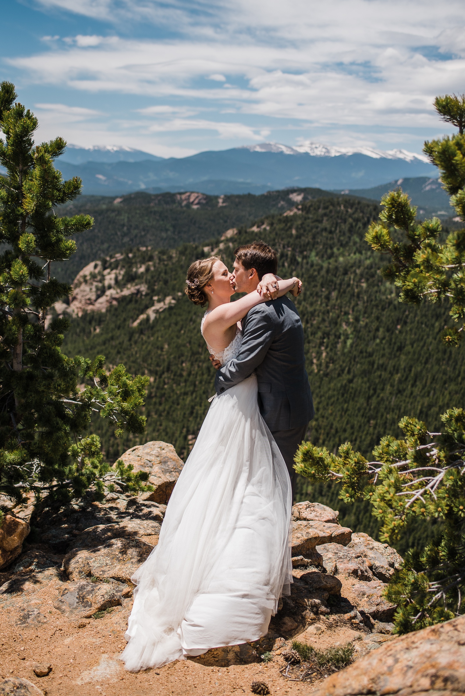 Bride and Groom kissing in on mountain top