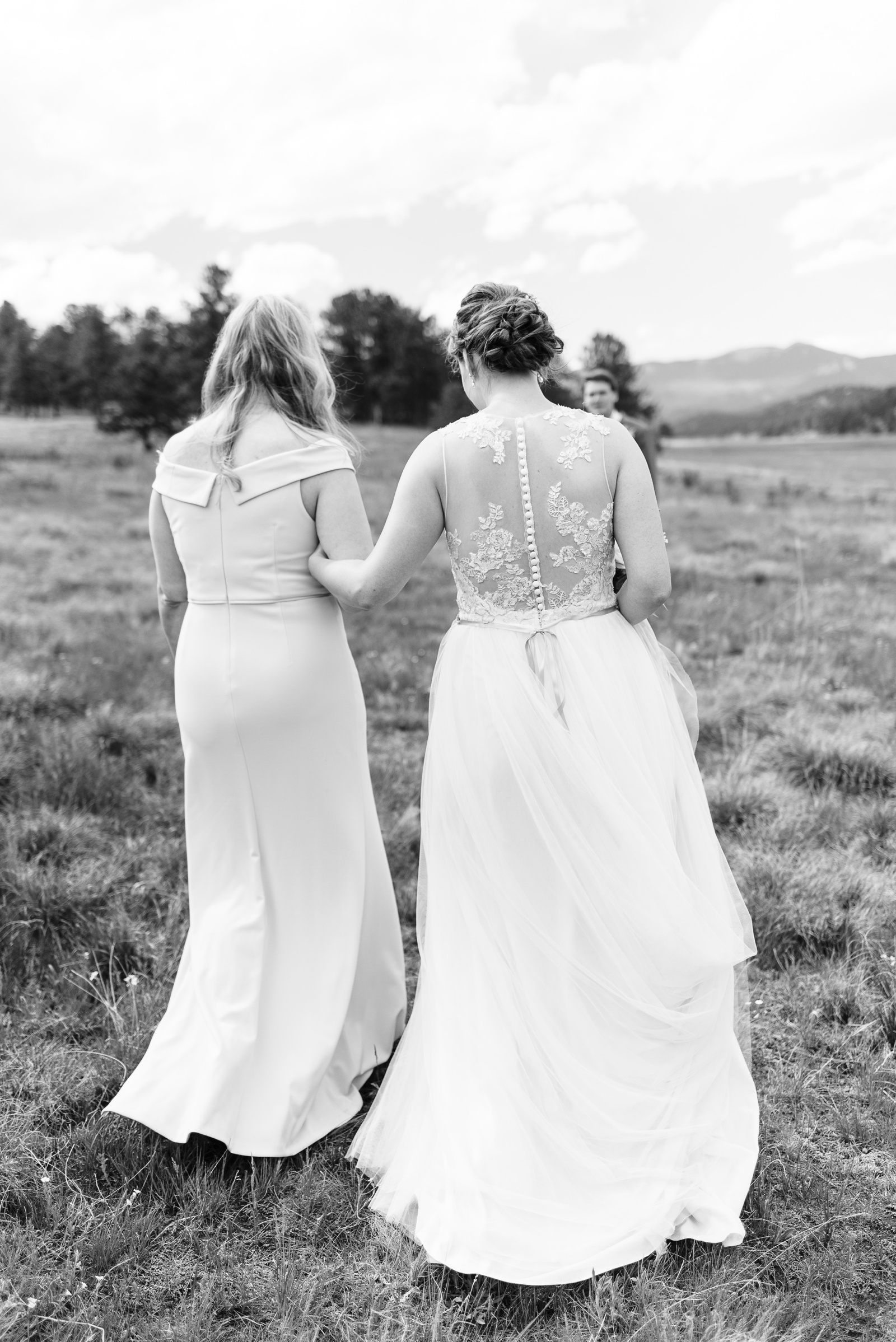 Bride and mom walking arm in arm