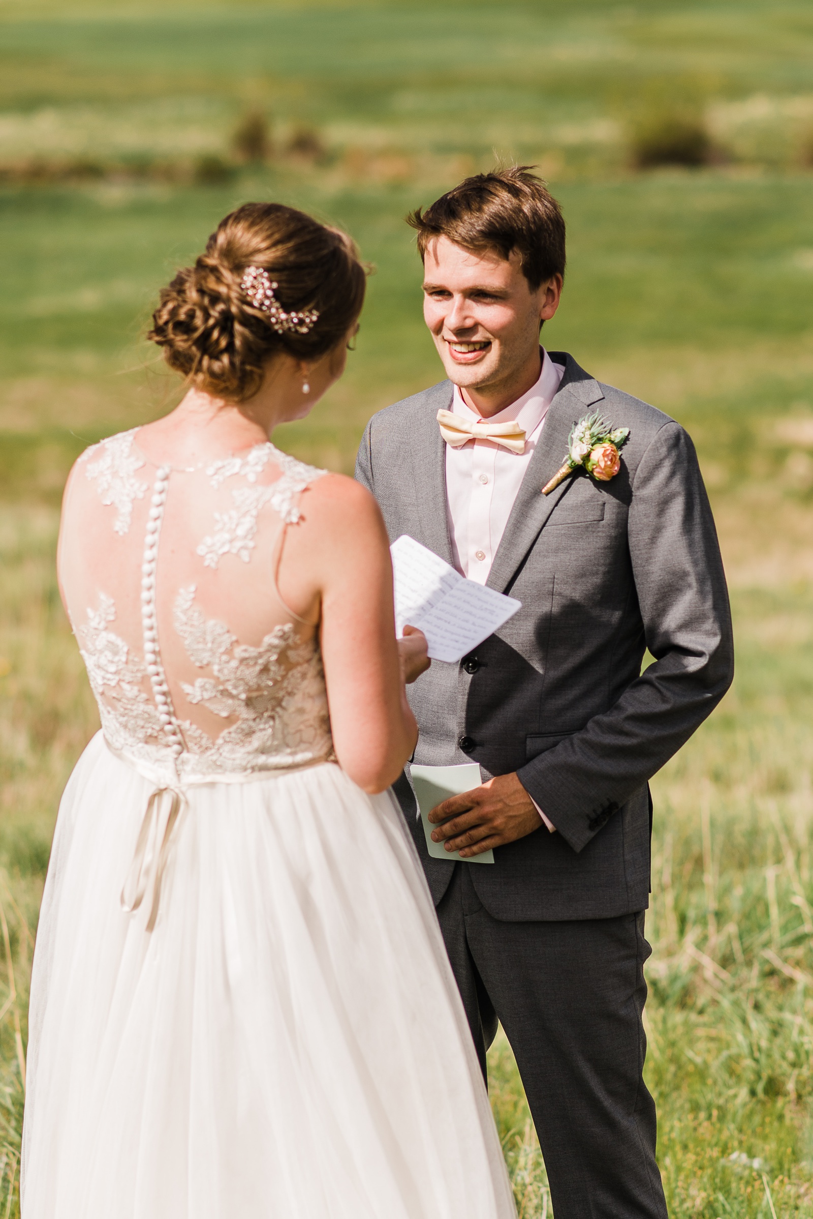 Groom smiling during vows