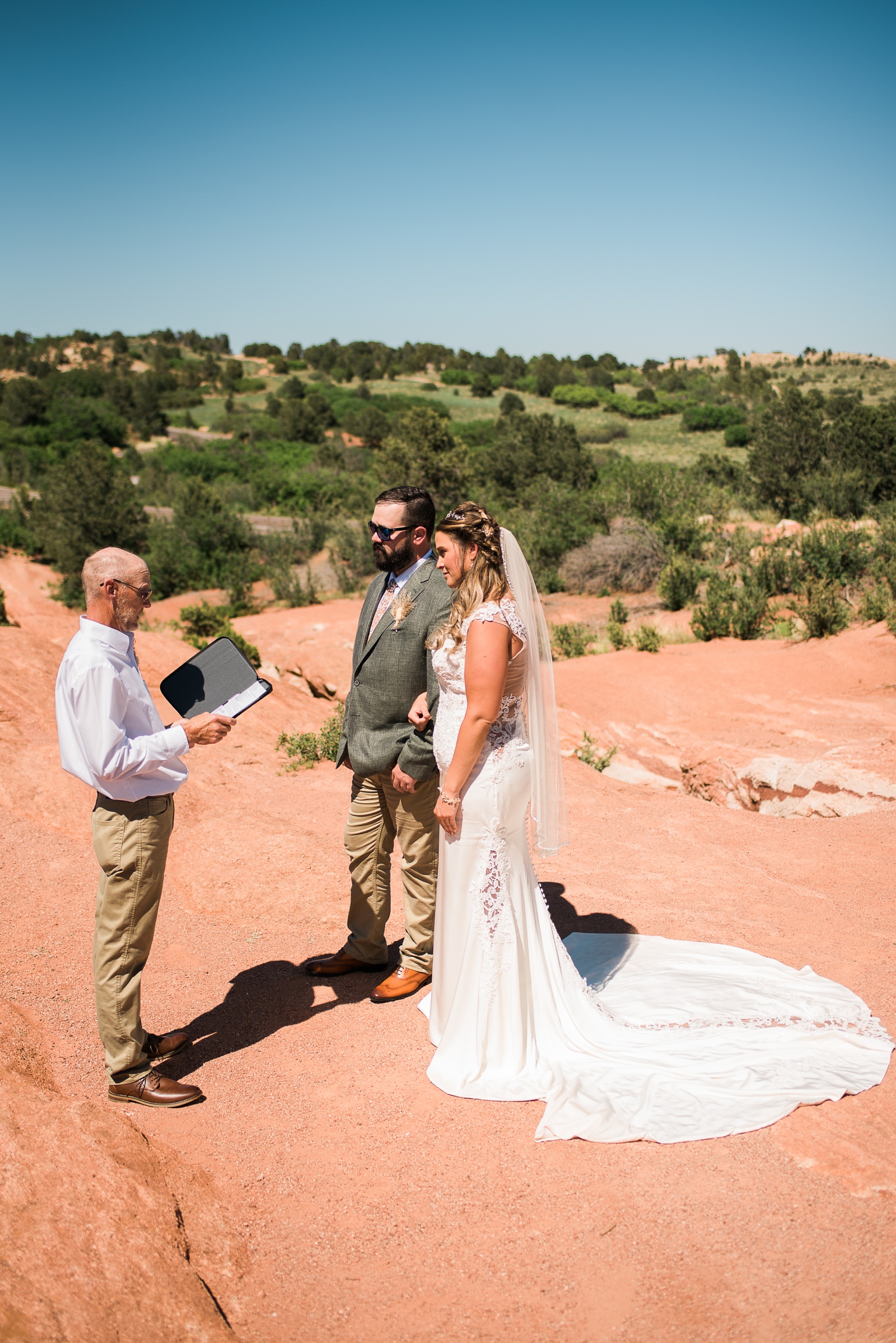 Officiant reading to bride and groom